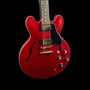 A Red Electric Guitar Is Shown Against A Black Background Wallpaper
