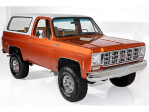 A Red Gmc Jimmy Parked Outdoors In A Scenic Environment Wallpaper