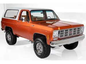 A Red Gmc Jimmy Parked Outdoors In A Scenic Environment Wallpaper