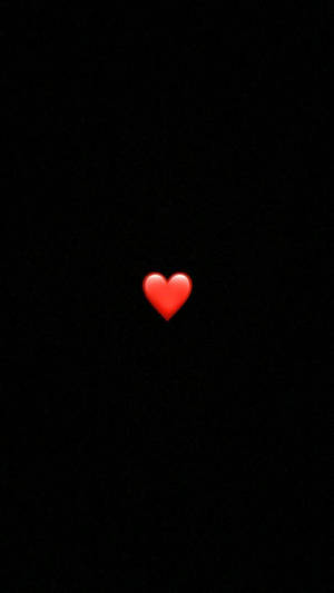 A Red Heart Is Lit Up In The Dark Wallpaper