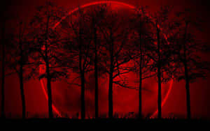 A Red Moon With Trees In The Background Wallpaper