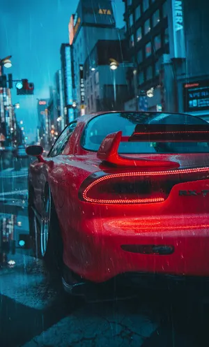 A Red Sports Car Is Parked On A City Street Wallpaper
