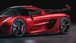 A Red Sports Car Is Shown In A Dark Room Wallpaper