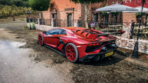 A Red Sports Car Parked In Front Of A Restaurant Wallpaper