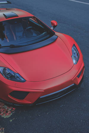 A Red Sports Car Parked On The Street Wallpaper