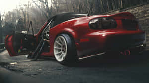 A Red Sports Car With Its Door Open Wallpaper