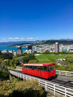 A Red Train Rolling Down The Tracks. Wallpaper