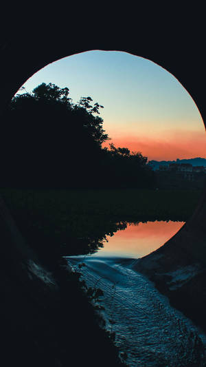 A River Flowing Through A Tunnel Wallpaper