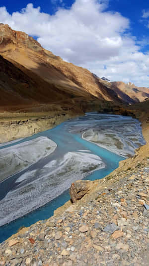 A River In The Mountains With A Blue Sky Wallpaper