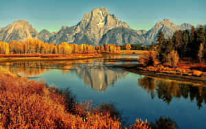 A River Surrounded By Mountains Wallpaper