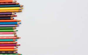 A Row Of Colored Pencils On A White Background Wallpaper