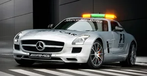 A Safety Car Leading The Way On A Race Track. Wallpaper