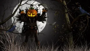 A Scarecrow Guards A Field Of Pumpkins Wallpaper