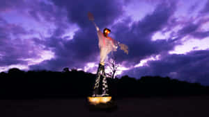 A Scarecrow In A Field At Dusk Wallpaper