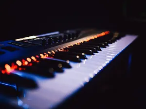 A Scenic View Of Autumn Trees With A Blue Sky And White Clouds Wallpaper