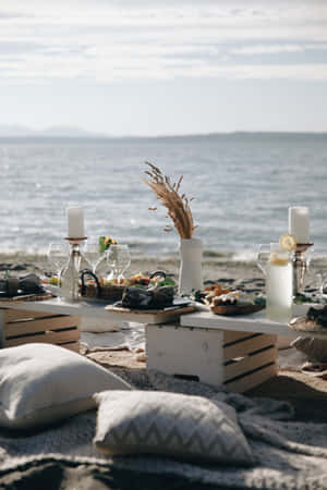 A Serene Beach Picnic By The Shore Wallpaper