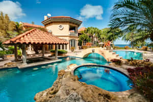 A Serene Beach Swimming Pool Surrounded By Palm Trees And Lounge Chairs Wallpaper