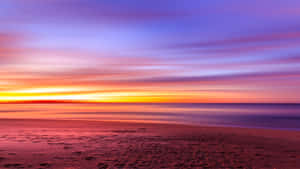 A Serene Beachscape At Sunset Wallpaper