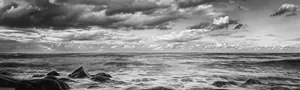 A Serene Black And White Ocean Scene Featuring Calm Waves Wallpaper