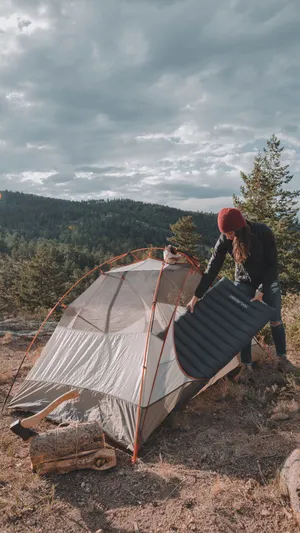 A Serene Minimalist Camping Scene Under A Starry Night Sky Wallpaper