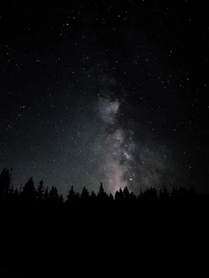 A Serene Night Sky Illuminated By A Full Moon. Wallpaper