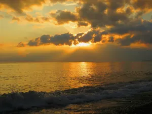 A Serene Sea Breeze At Sunset Wallpaper