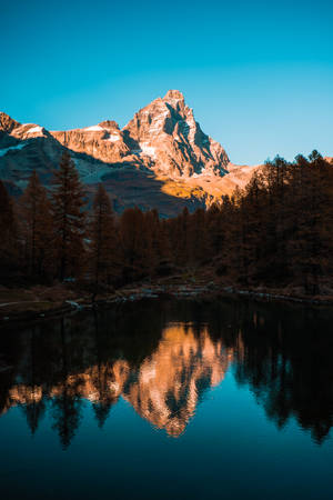 A Serene View Of A Mountain And Lake Wallpaper