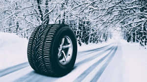 A Set Of Winter Tires On Snowy Terrain Wallpaper