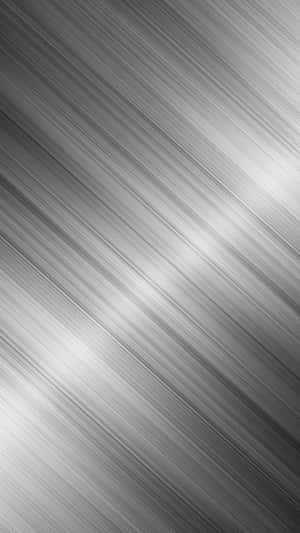 A Shiny Black Metallic Surface Reflects On A Brightly Lit Room Wallpaper