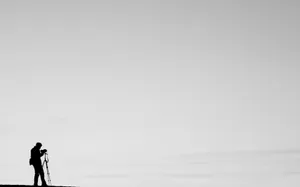 A Silhouette Of A Minimal Photographer Wallpaper