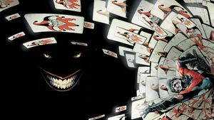 A Sinister Joker Card In A Mysterious Black Background Wallpaper