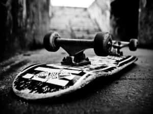 A Skateboard Is Laying On The Ground Wallpaper