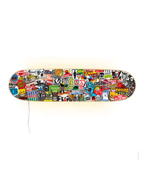 A Skateboard With Many Different Stickers On It Wallpaper