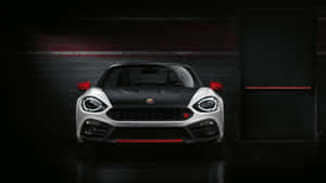 A Sleek Abarth Sportscar On The Move Wallpaper