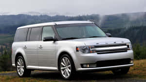 A Sleek And Modern Ford Flex On Scenic Mountain Road Wallpaper