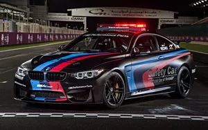 A Sleek And Modern Safety Car Leading The Race On The Track Wallpaper