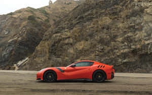 A Sleek And Powerful Red Ferrari F12 Berlinetta In Action Wallpaper