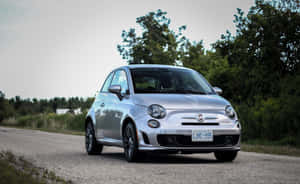 A Sleek And Stylish Red Fiat 500 Parked On A City Street Wallpaper