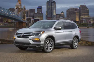 A Sleek And Versatile Honda Pilot On The Road Wallpaper