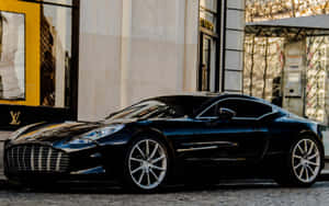 A Sleek Aston Martin One-77 In A Stunning Outdoor Setting Wallpaper