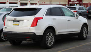 A Sleek Black Cadillac Xt5 Parked On A Modern City Street Wallpaper