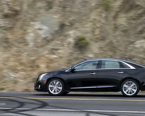 A Sleek, Black Cadillac Xts In An Urban Setting Showcasing Its Modern Design And Luxurious Appeal. Wallpaper