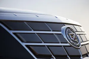 A Sleek Cadillac Elr Driving On A Smooth Highway Wallpaper