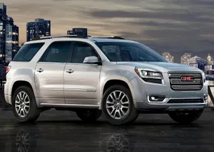 A Sleek Gmc Acadia Driving On A Picturesque Highway Wallpaper