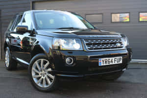 A Sleek Land Rover Freelander On A Scenic Mountain Drive Wallpaper