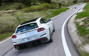 A Sleek Red Ferrari Gtc4lusso In Motion Wallpaper