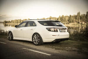 A Sleek Saab 9-4x In A Luxurious Outdoor Setting Wallpaper
