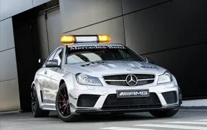 A Sleek Safety Car Leading The Race On The Track Wallpaper