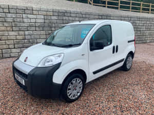 A Sleek White Fiat Fiorino Van Parked On A City Street. Wallpaper