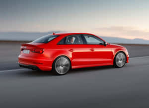 A Sleek White Sedan Car Driving On A Picturesque Highway Wallpaper